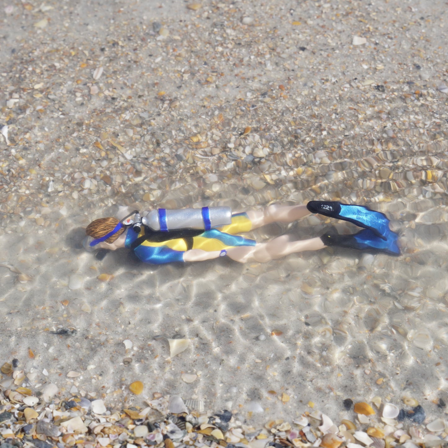 Safari Ltd Kevin scuba diver figurine submerged in shallow ocean water lifestyle shot